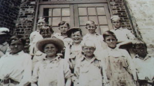 Necessity School. Carroll Williams 3rd from left, back row